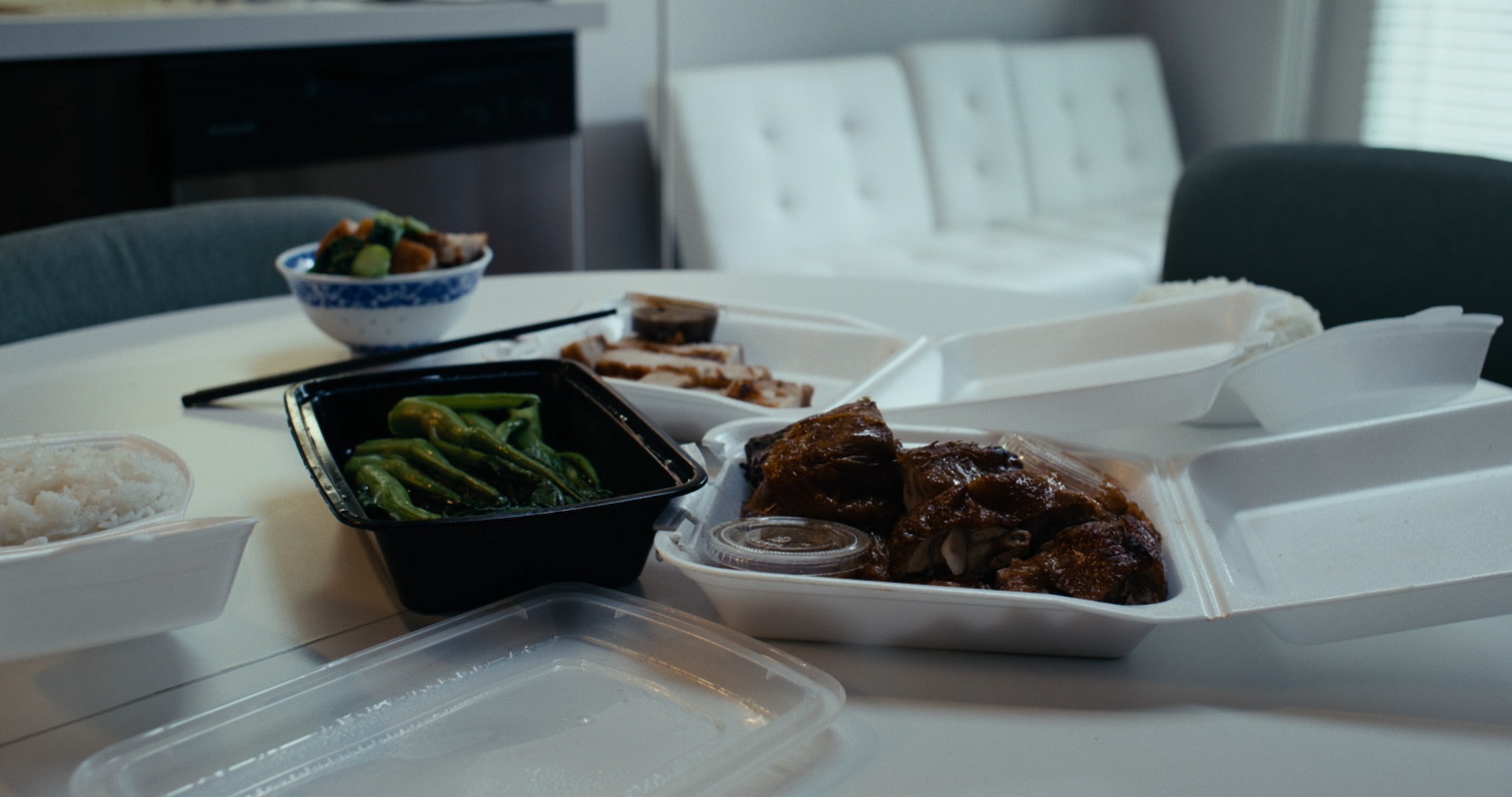 Takeout containers and rice bowls left open on the table.